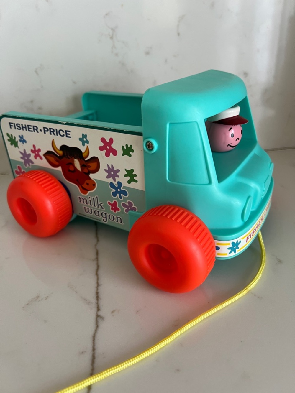 Fisher-Price Teal Milk Wagon Pull Toy with Bright Orange Wheels